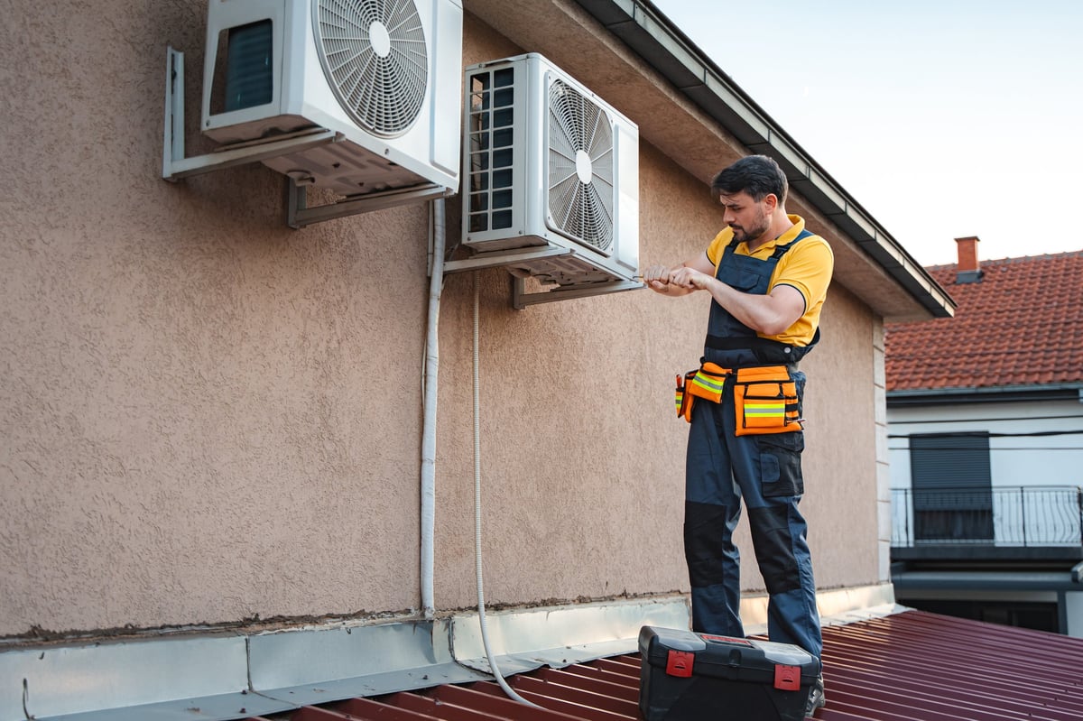 HVAC technician installing air conditioner